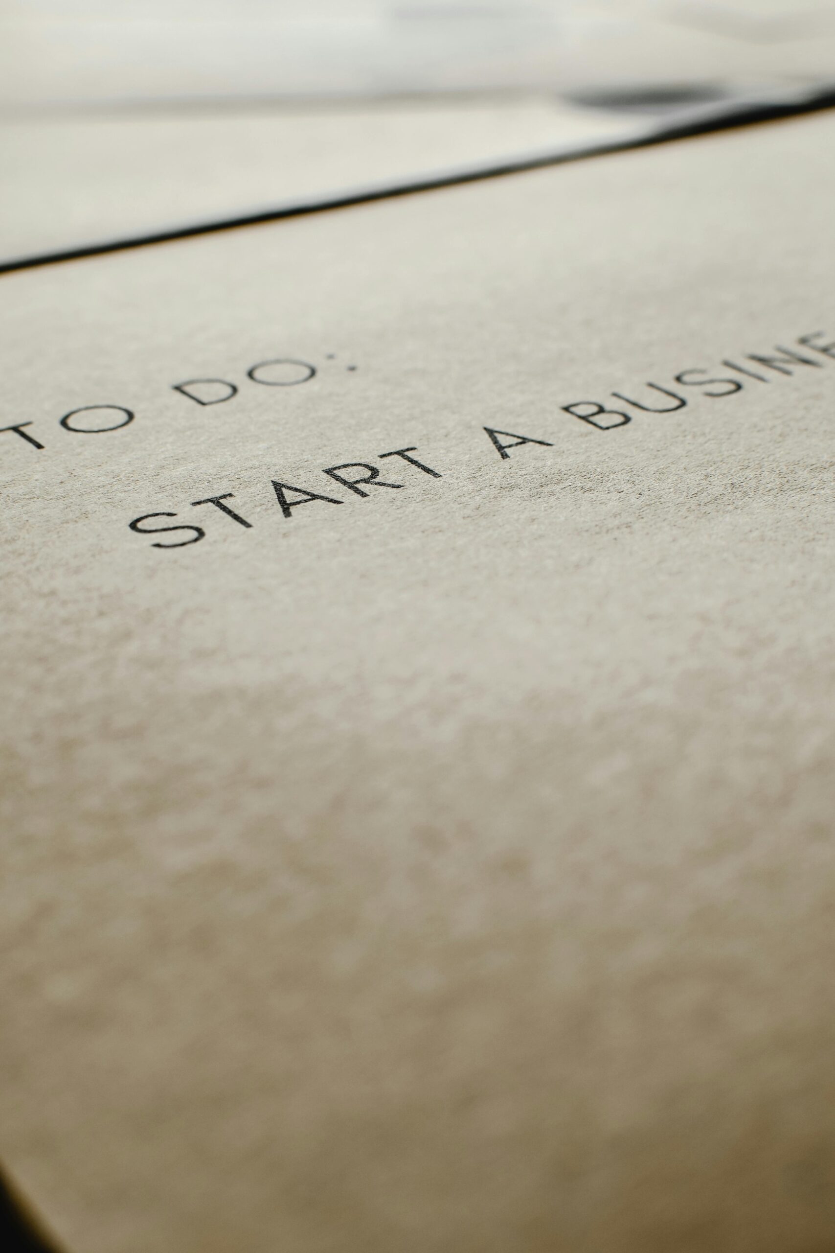 A focused image of a to-do list featuring 'Start a Business' on paper.